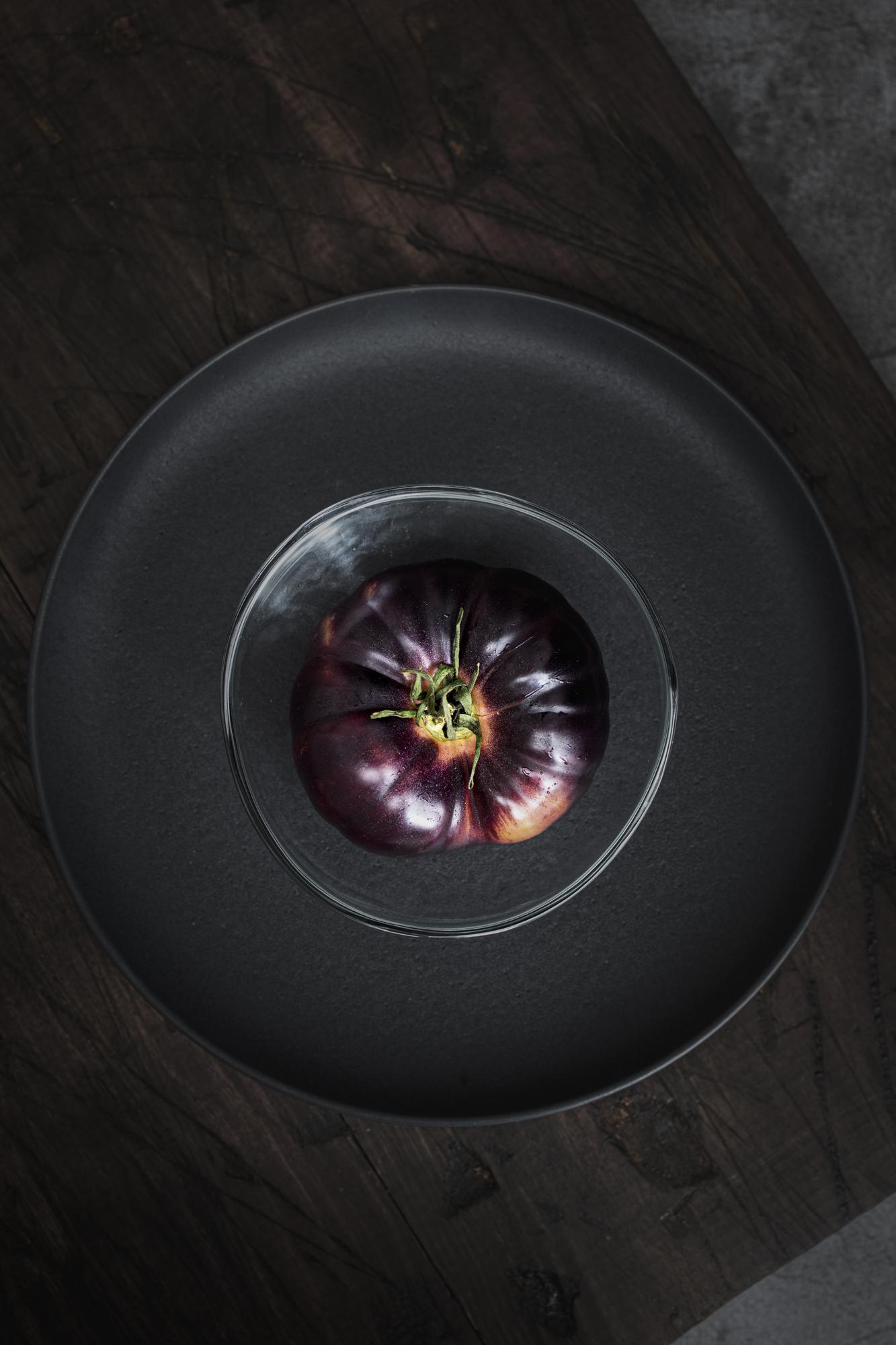 Close-up of plated culinary composition on dark surface