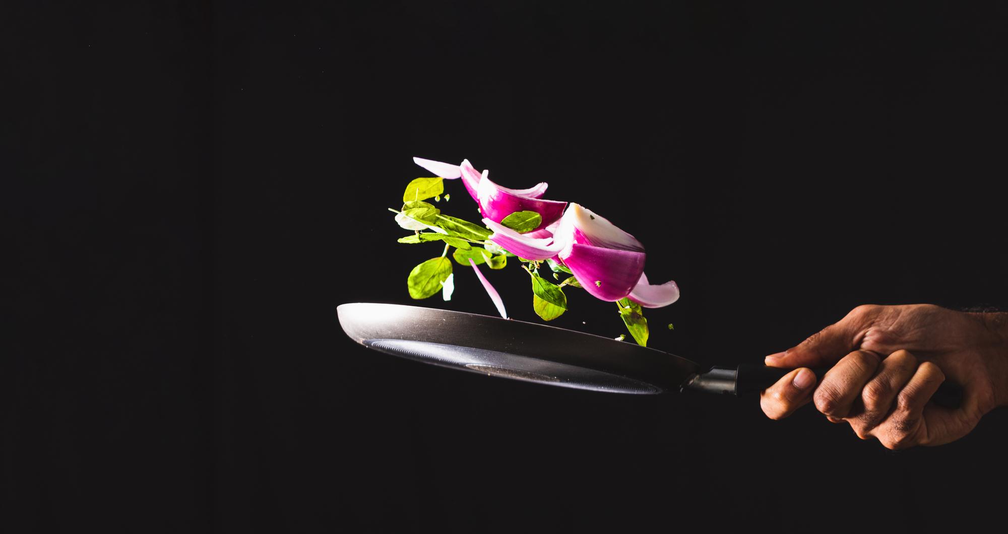 Chef plating a modern dish with neon lighting